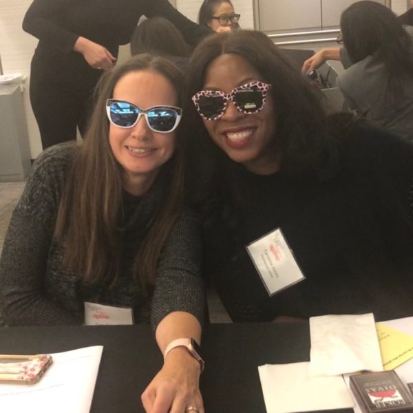 Two women smiling by playing Poker
